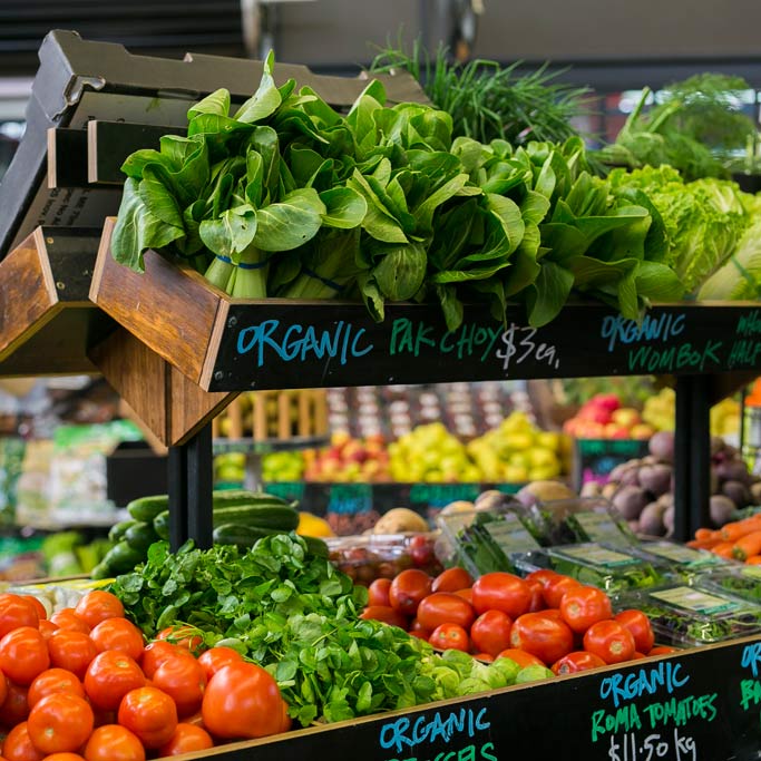 Leafy greens and tomatoes on display